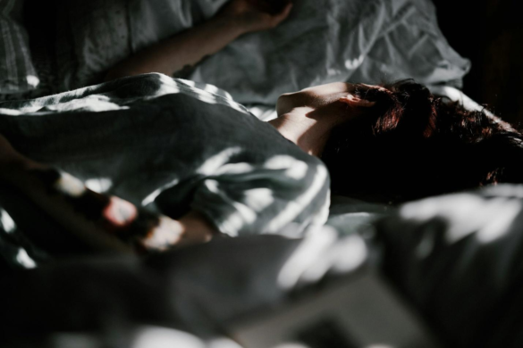 A person sleeping in bed during the day before getting an actigraphy device